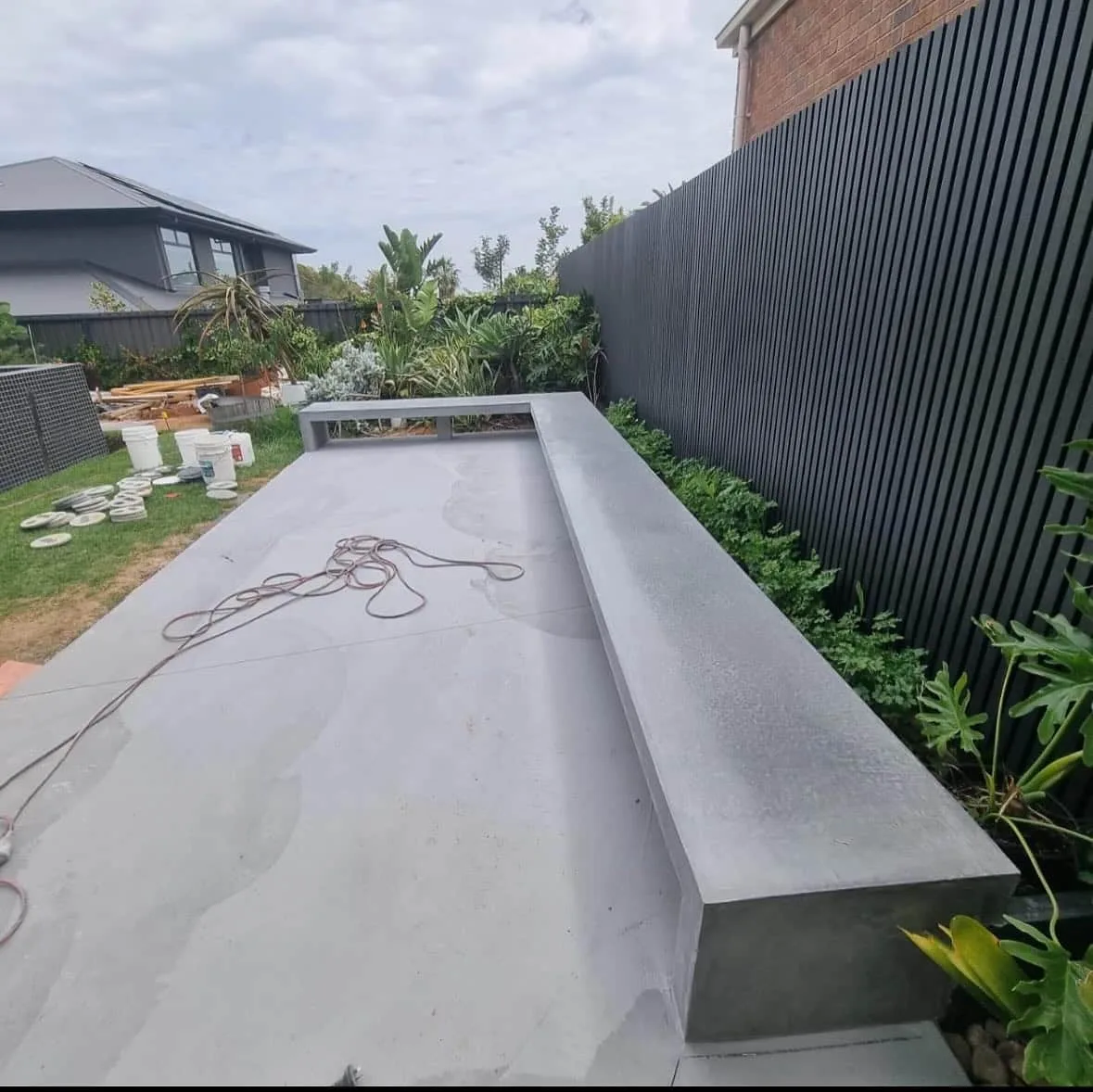 Concrete slab and raised concrete bench in a new garden