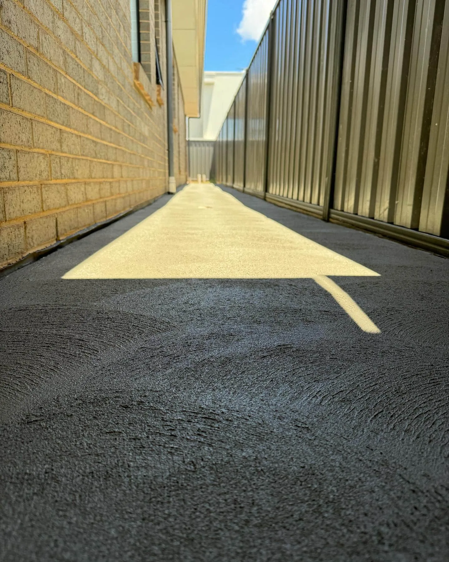 Plain concrete side path between two buildings